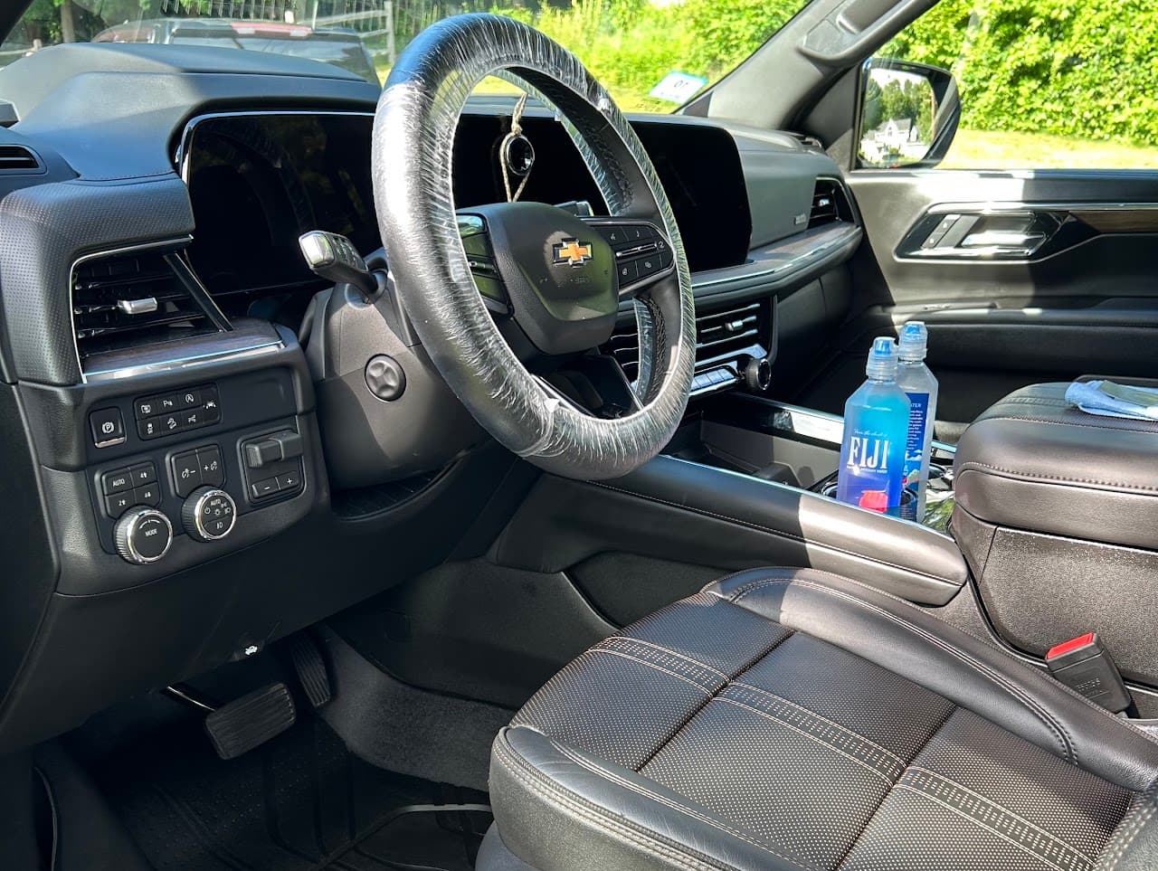 Detailed SUV front cabin with steering wheel wrap and leather seats